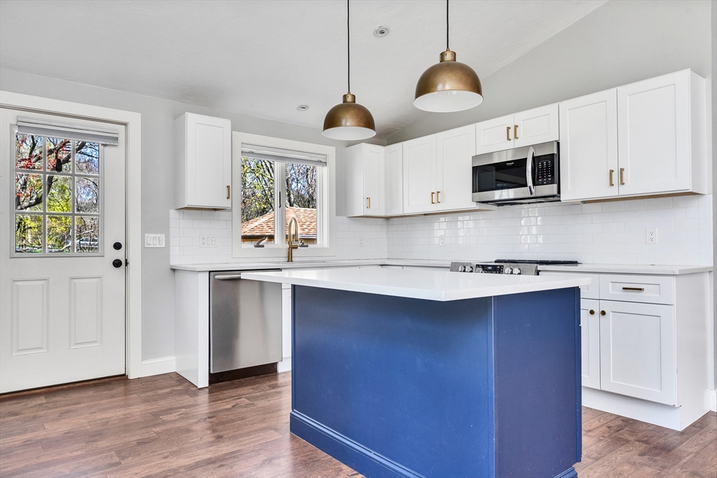 151 Wheeler Street Rehoboth, MA 02769 - Photo 7 of 36 a kitchen with stainless steel appliances a stove a sink and a microwave