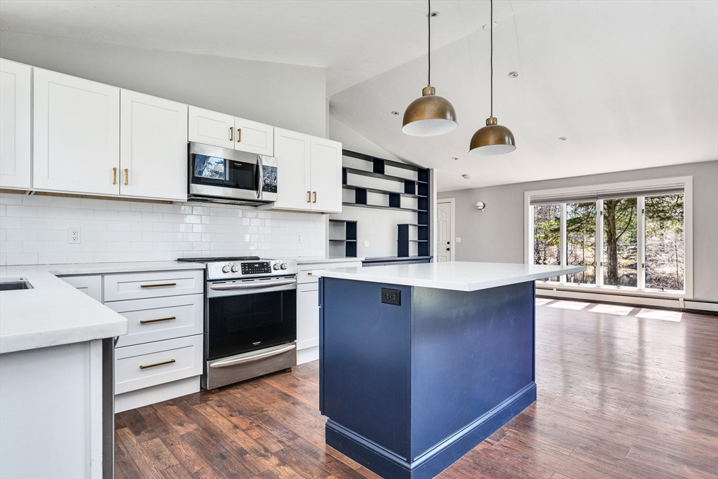 151 Wheeler Street Rehoboth, MA 02769 - Photo 8 of 36 a kitchen with stainless steel appliances granite countertop a sink a stove and a refrigerator