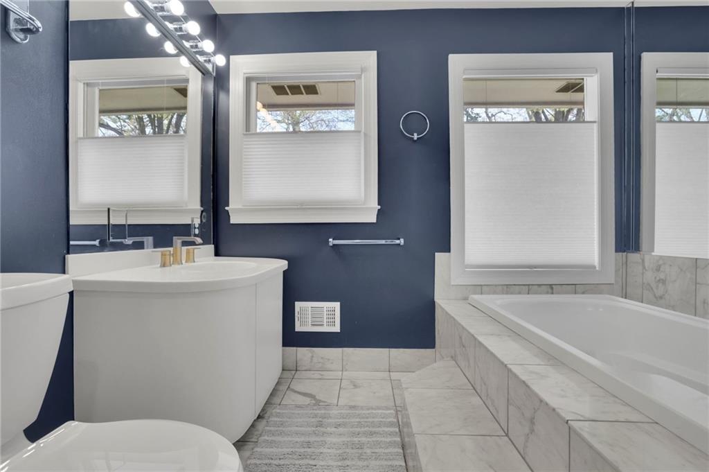 2476 Burnt Leaf Lane Decatur, GA 30033 - Photo 19 of 41 a bathroom with a bathtub a mirror a sink and a toilet