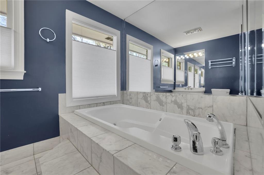 2476 Burnt Leaf Lane Decatur, GA 30033 - Photo 20 of 41 a bath tub sitting in a bathroom and mirror