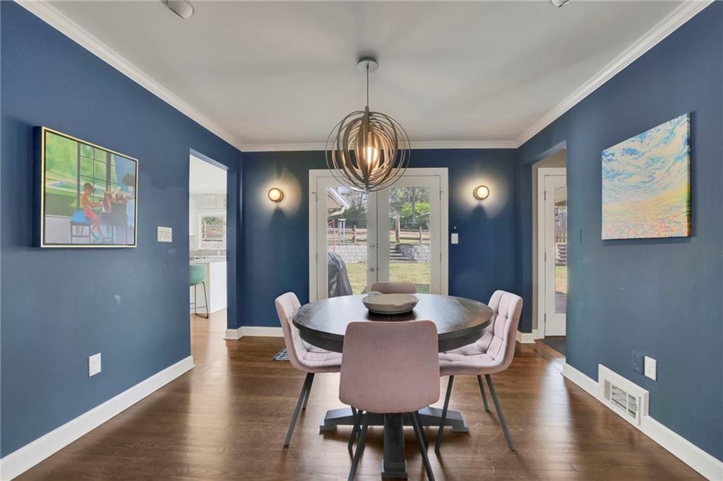 2476 Burnt Leaf Lane Decatur, GA 30033 - Photo 7 of 41 a dining room with wooden floor a chandelier a wooden table and chairs