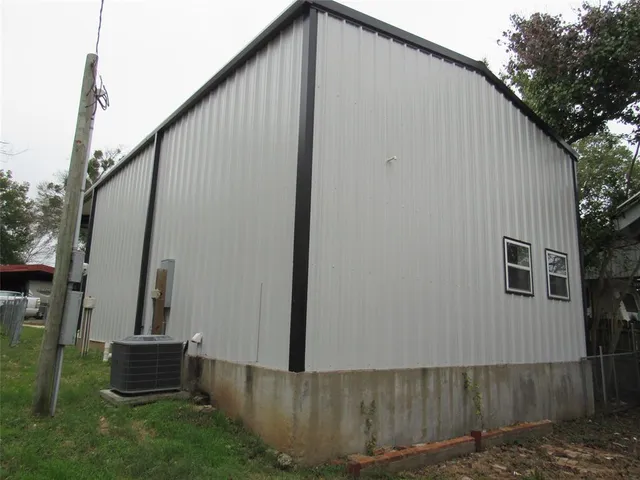 a backyard of a house with wooden fence and trees