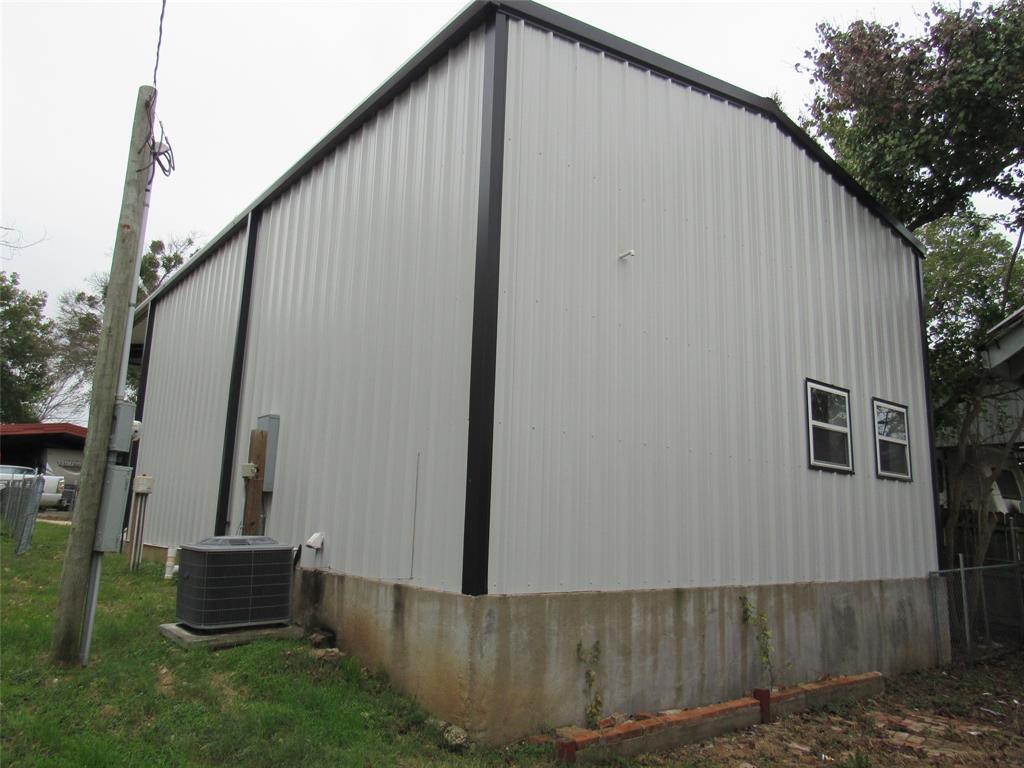 108 Private Road Whitney, TX 76692 - Photo 13 of 14 a backyard of a house with wooden fence and trees