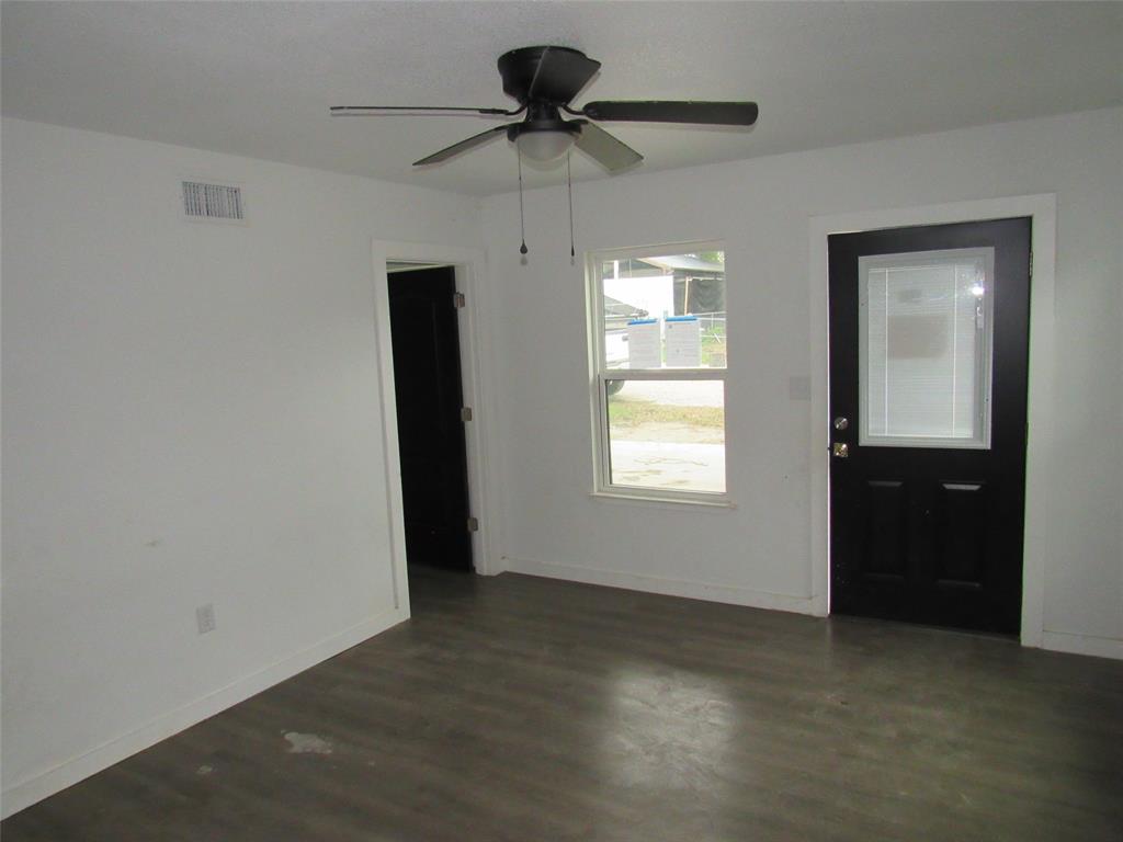 108 Private Road Whitney, TX 76692 - Photo 2 of 14 an empty room with windows and fan