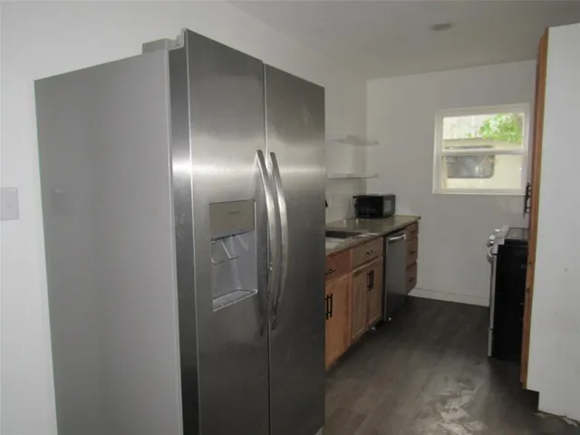 a kitchen with cabinets and stainless steel appliances