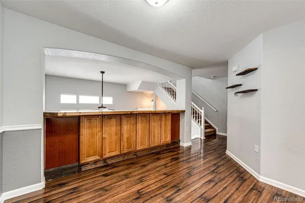 a view of a room with wooden floor