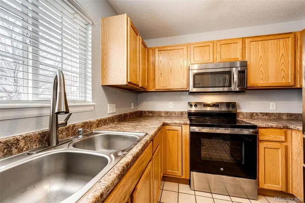 a kitchen with granite countertop a sink and a stove top oven