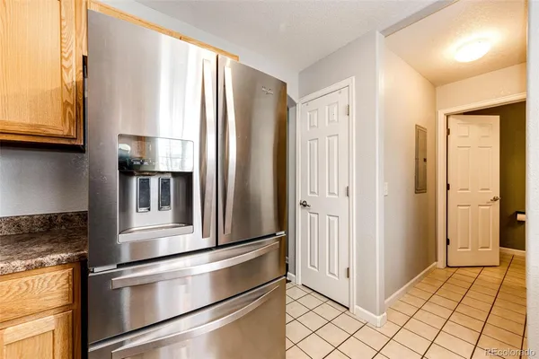 a kitchen with stainless steel appliances granite countertop a refrigerator and a stove