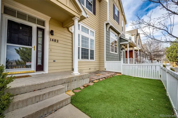 a view of a house with a yard and pathway