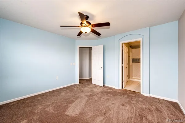 a view of a livingroom with a ceiling fan and window