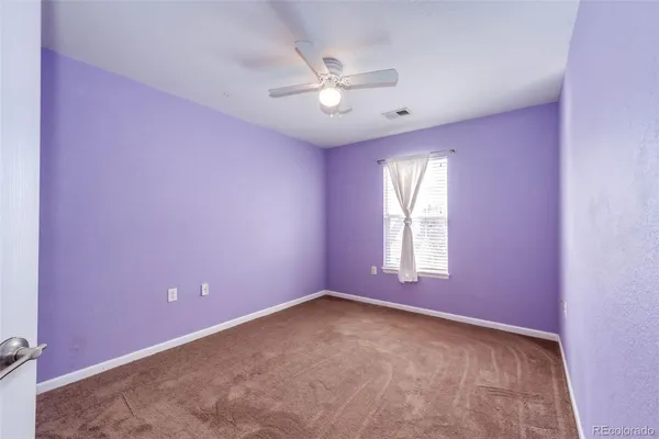 a view of a livingroom with a ceiling fan and window