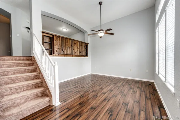 a view of an entryway with wooden floor and staircase