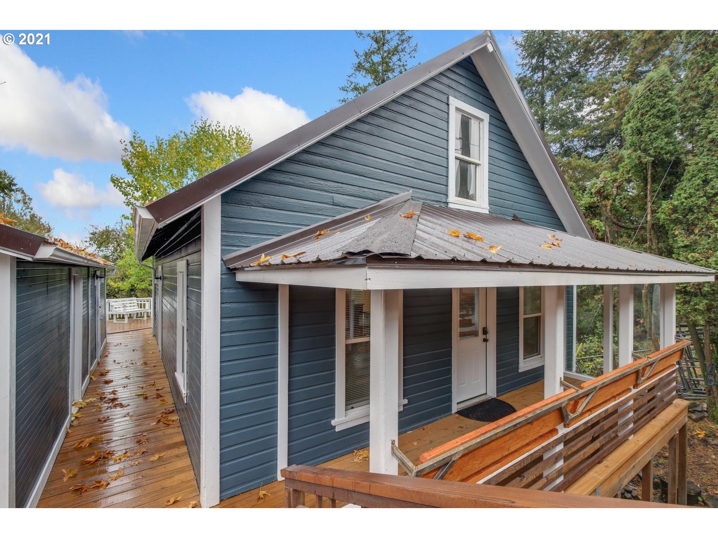 16946 Northwest St Helens Road Portland, OR 97231 - Photo 1 of 31 a view of small white house with a large window and wooden fence