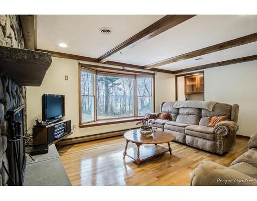 18 Argilla Road Methuen, MA 01844 - Photo 12 of 30 a living room with furniture a flat screen tv and a large window