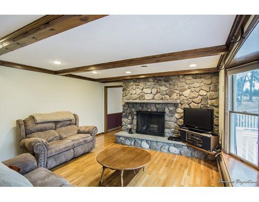 18 Argilla Road Methuen, MA 01844 - Photo 14 of 30 a living room with furniture a flat screen tv and a fireplace