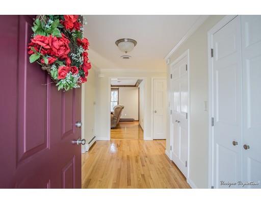 18 Argilla Road Methuen, MA 01844 - Photo 2 of 30 a hallway with flowers and wooden floor