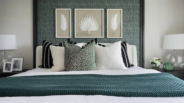 a bedroom with a bed and a painting on the wall