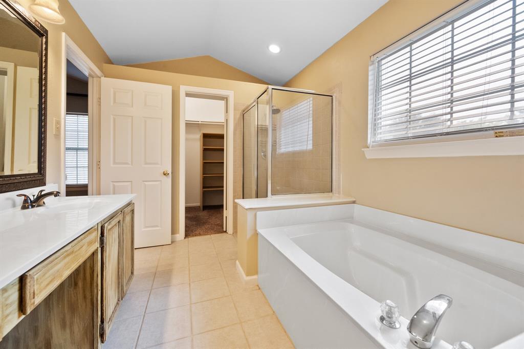 7517 Point Reyes Drive Fort Worth, TX 76137 - Photo 22 of 30 Spacious bathroom featuring a built-in soaking tub, a separate glass-enclosed shower, and a vanity with a light-colored countertop