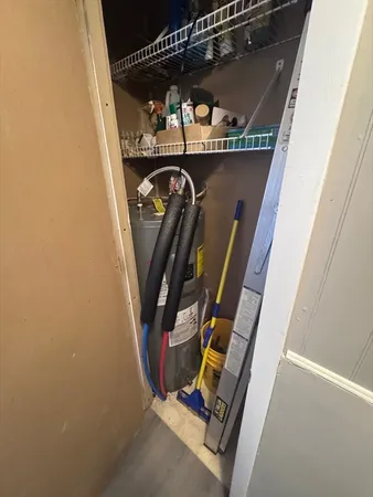 a view of walk in closet with clothes