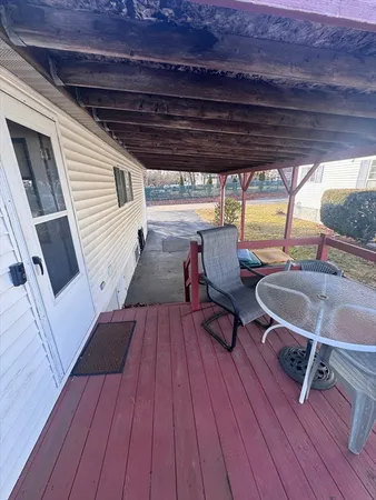 a outdoor space with wooden floor a barbeque oven and furniture