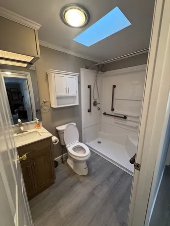 a bathroom with a toilet sink and mirror