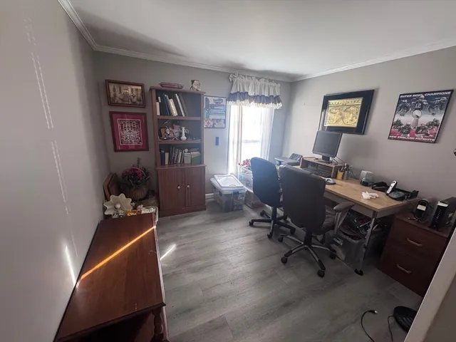 a view of a workspace with furniture and a window