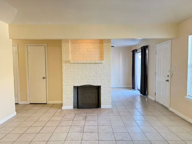 an empty room with fireplace