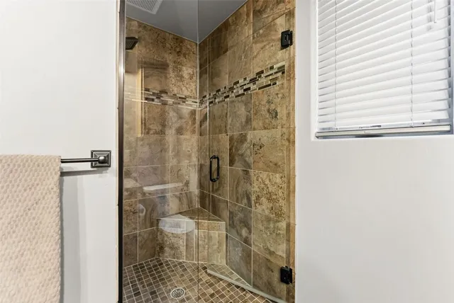 a bathroom with a shower and a toilet