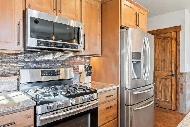 a kitchen with a stove and a refrigerator