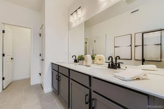 a bathroom with a double vanity sink mirror and