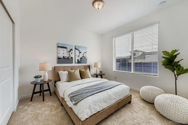 a bedroom with a bed and balcony