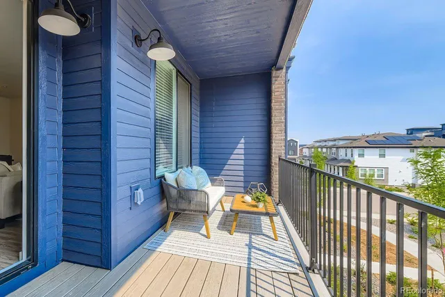 a view of a balcony with chair and brick wall
