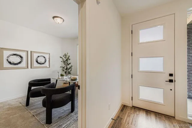 a view of workspace with wooden floor lounge chair and windows