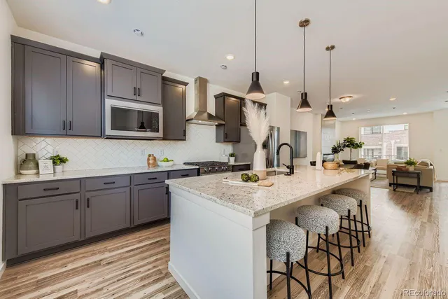 a kitchen with stainless steel appliances kitchen island granite countertop a sink counter space and cabinets