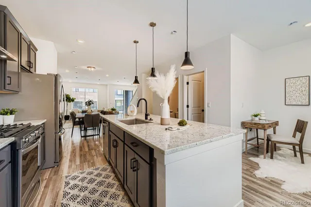 a kitchen with sink stove and dining table