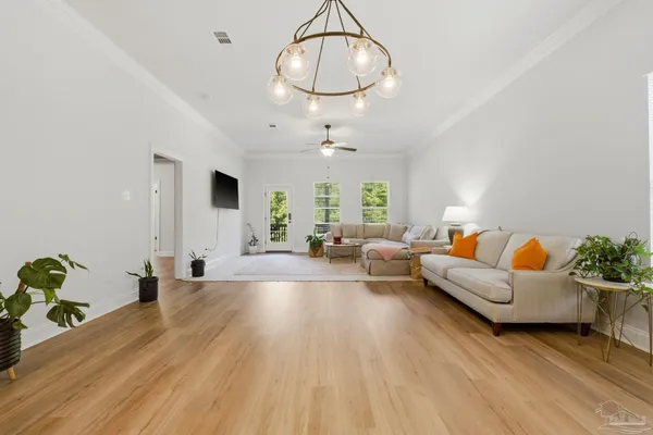 a living room with furniture chandelier and a chandelier