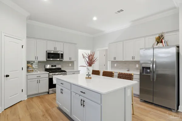 a kitchen with white cabinets stainless steel appliances and sink