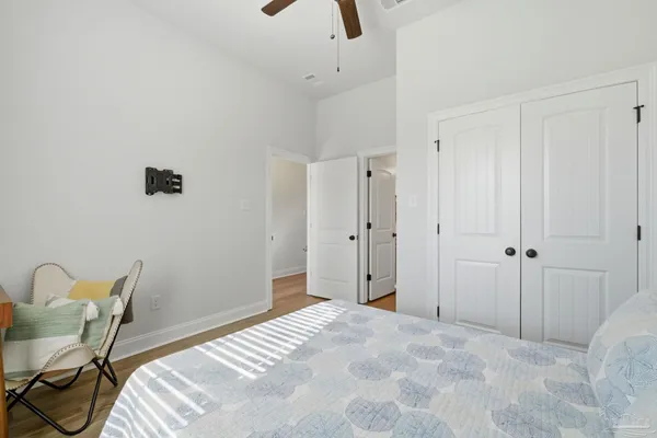 a bedroom with a bed and a chair
