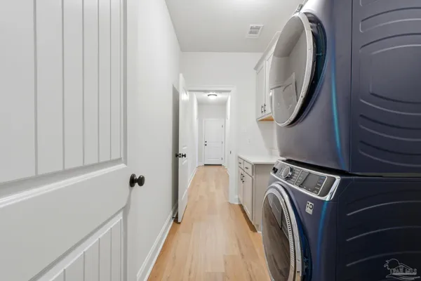 a view of a hallway with washer and dryer