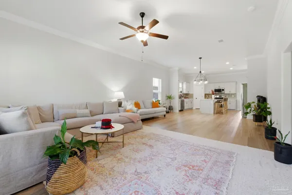 a living room with furniture and a chandelier