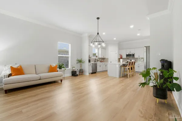 a living room with furniture and kitchen view