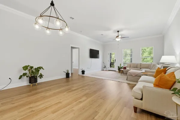 a living room with furniture and a chandelier