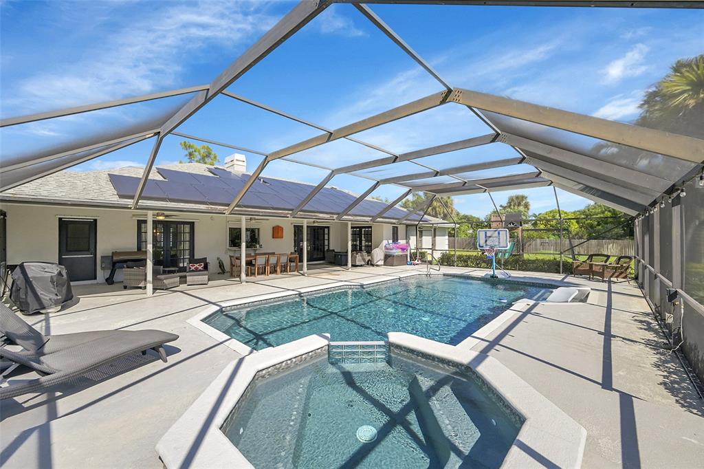 a view of a patio with table and chairs under an umbrella