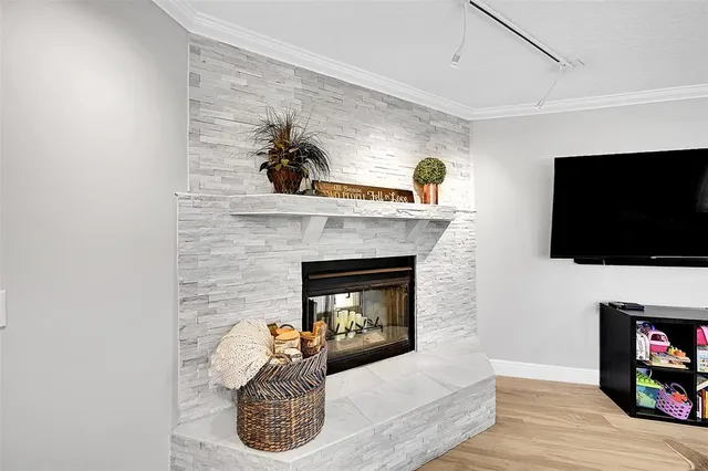 a dining room with furniture a chandelier and wooden floor