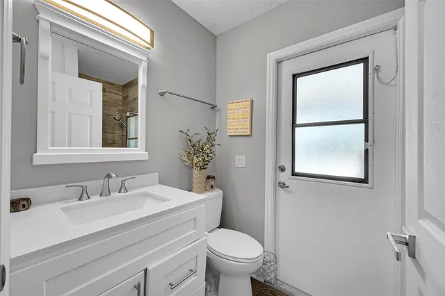 a kitchen with stainless steel appliances kitchen island granite countertop a stove and white cabinets
