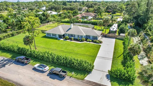 an aerial view of a house with a yard
