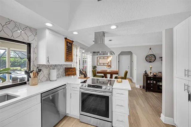 a living room with a fireplace furniture a potted plant and a fireplace