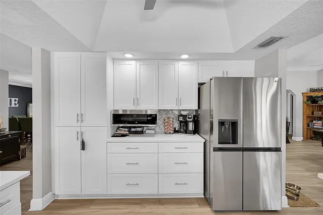 a kitchen with stainless steel appliances a sink and cabinets