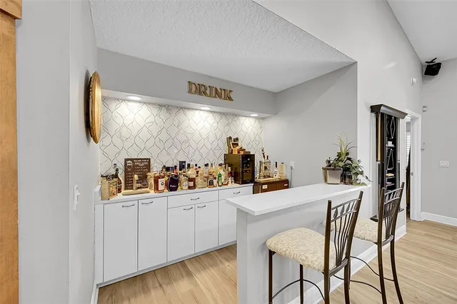 a living room with furniture a ceiling fan and a window