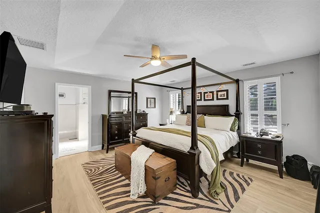 a bedroom with a bed and a tv